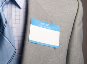 Close-up photo of a name tag on a suit jacket.