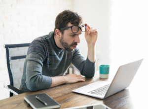 Picture of a man looking at his laptop