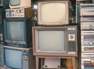 Picture showing stack of old TVs